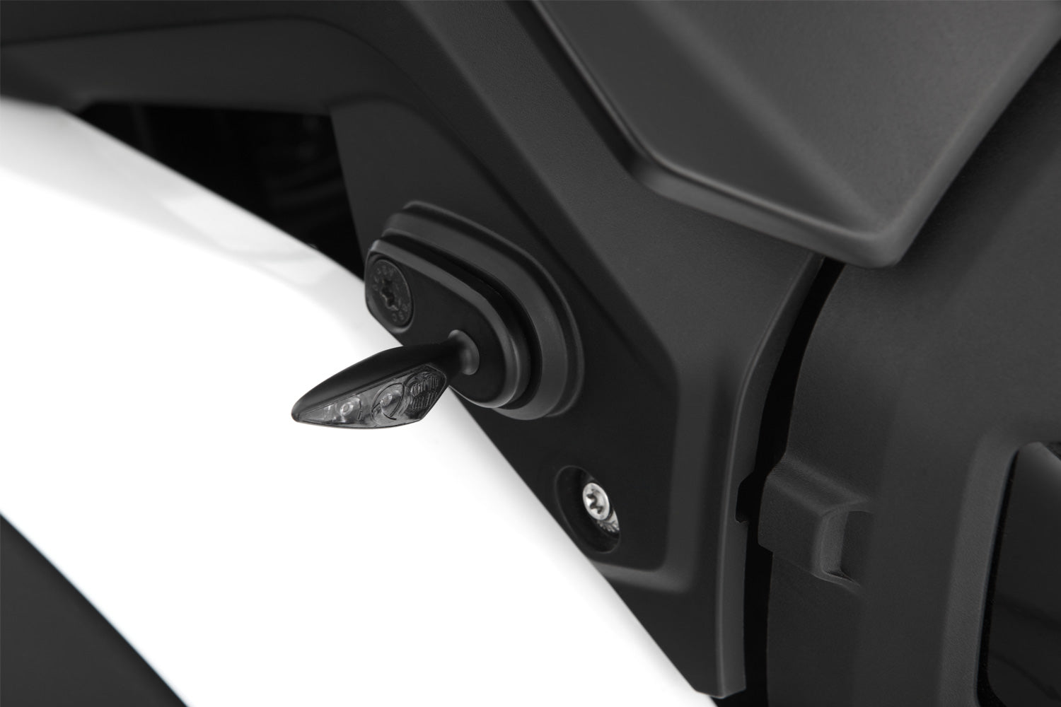 This adapter covers the opening on the original indicator bracket and simultaneously lets you attach accessory indicators.