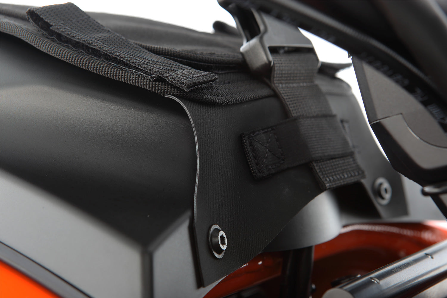 The mounting system is attached to the vehicle with minimal hand pressure and the tank bag can be quickly fastened to it.