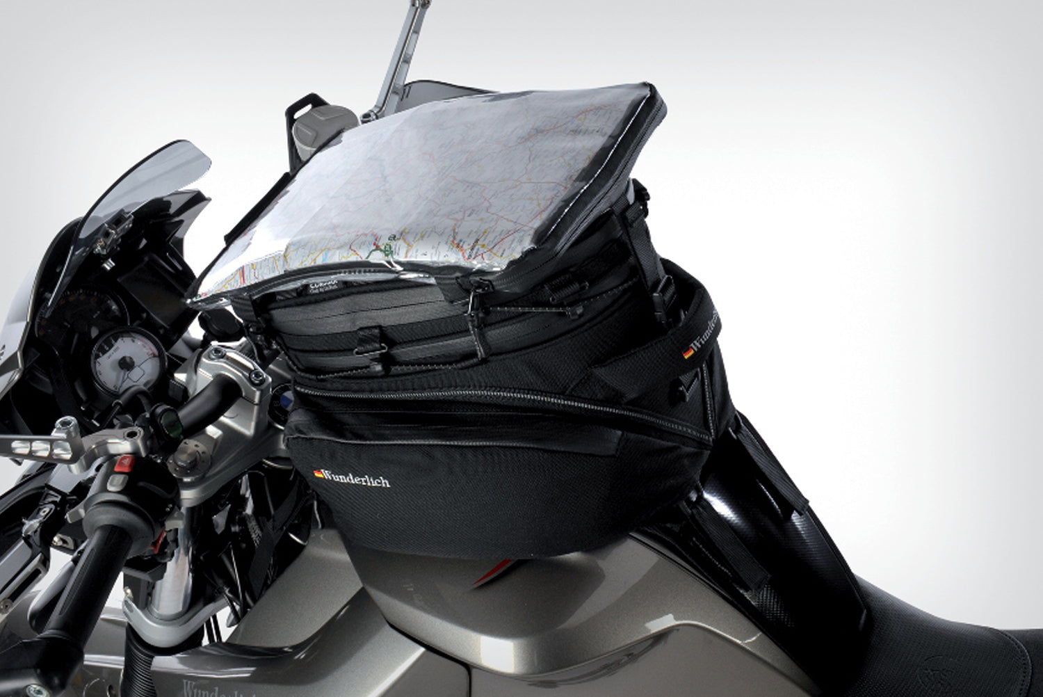 The mounting system is attached to the vehicle with minimal hand pressure and the tank bag can be quickly fastened to it. 
