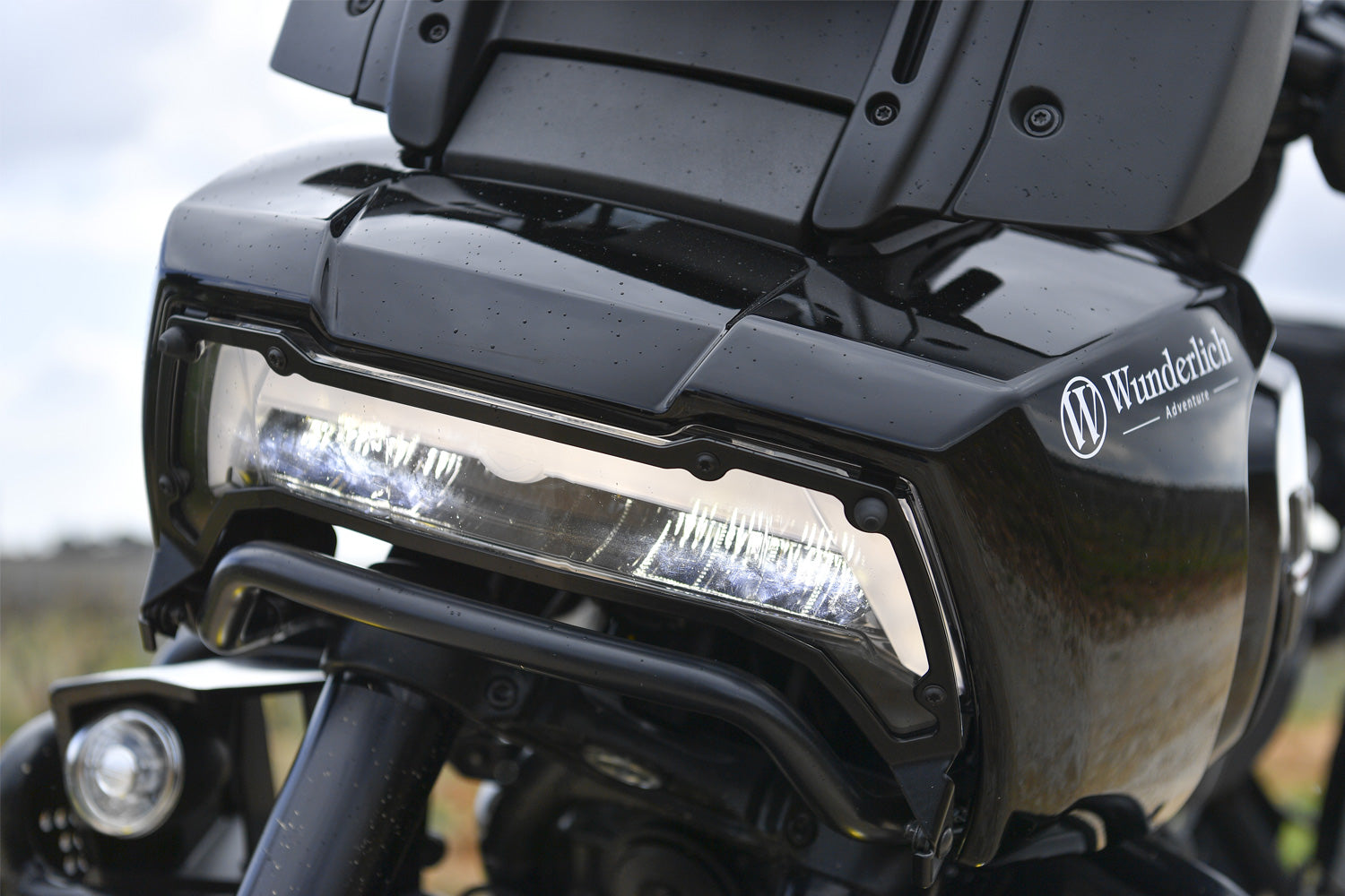 Wunderlich headlight protection grill for the Harley-Davidson Pan America 1250 reliably protects the original headlight from expensive...